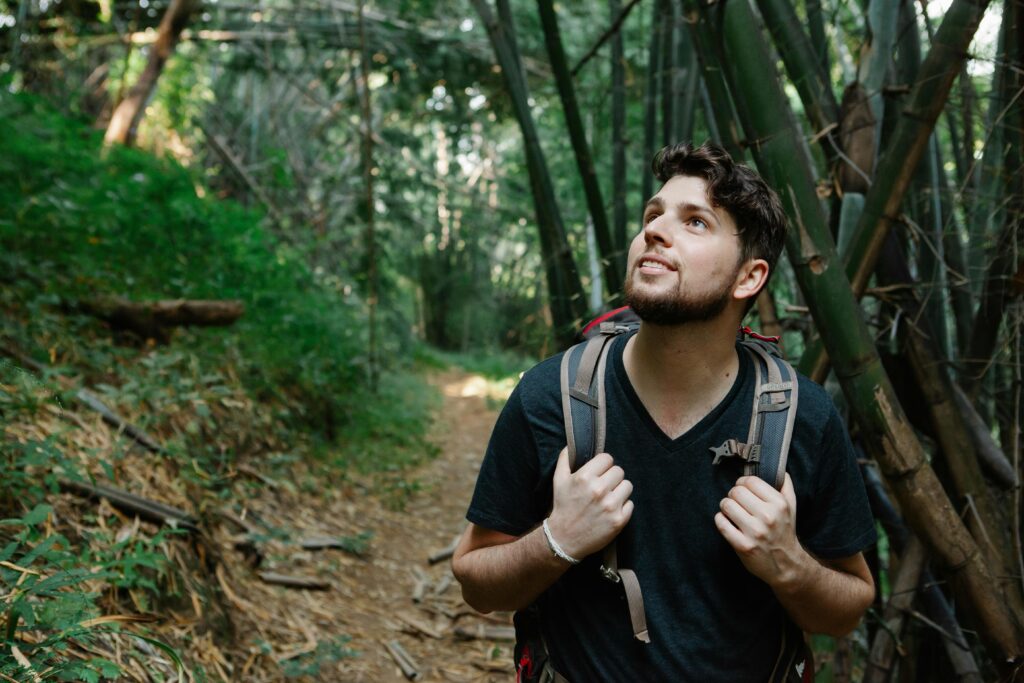 A man hiking a trail with determination, symbolizing progress and growth in a men over 35 life overhaul.