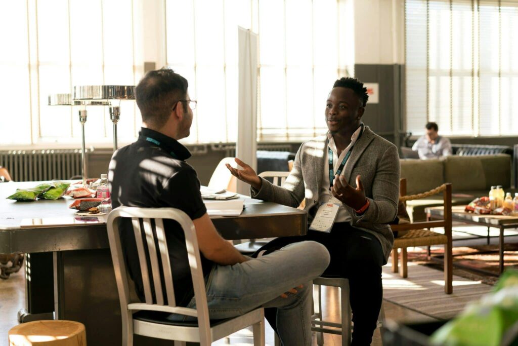 A coach mentoring a man over 35 outdoors, illustrating the power of iron sharpens iron relationships.