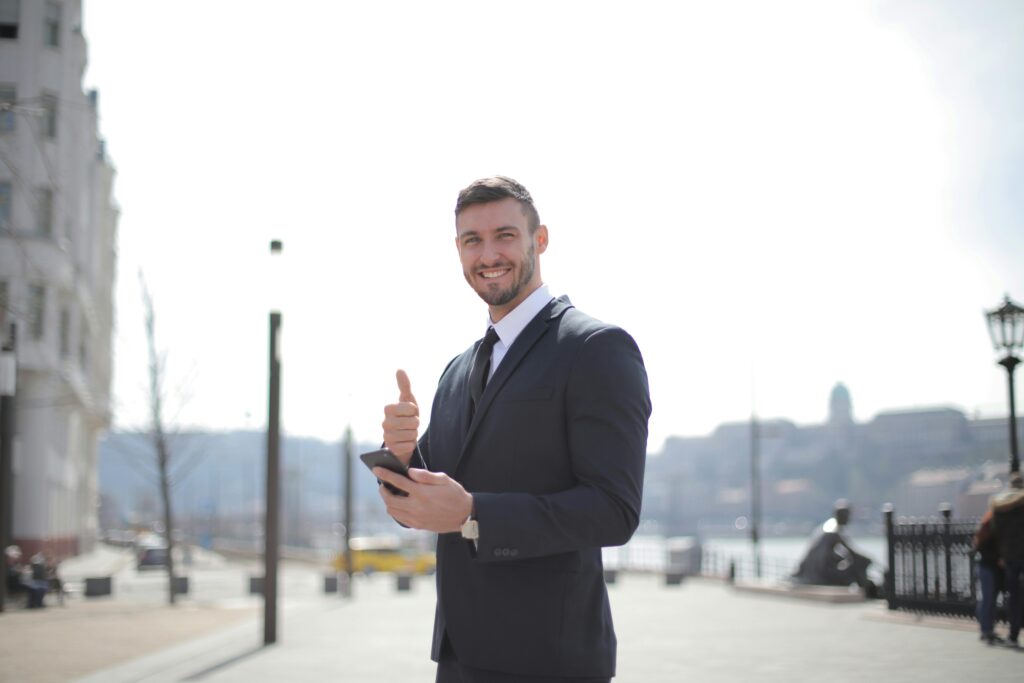 Confident man smiling outdoors, representing success and happiness after overcoming setbacks in life.