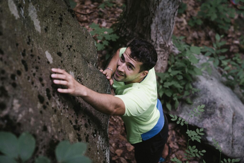 A person climbing a steep incline, showing the struggle to overcome fear and rise above limitations.